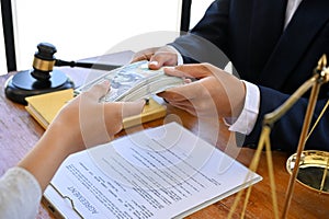 A female client in the office with her lawyer,Â giving bribes to her lawyer to win the lawsuit